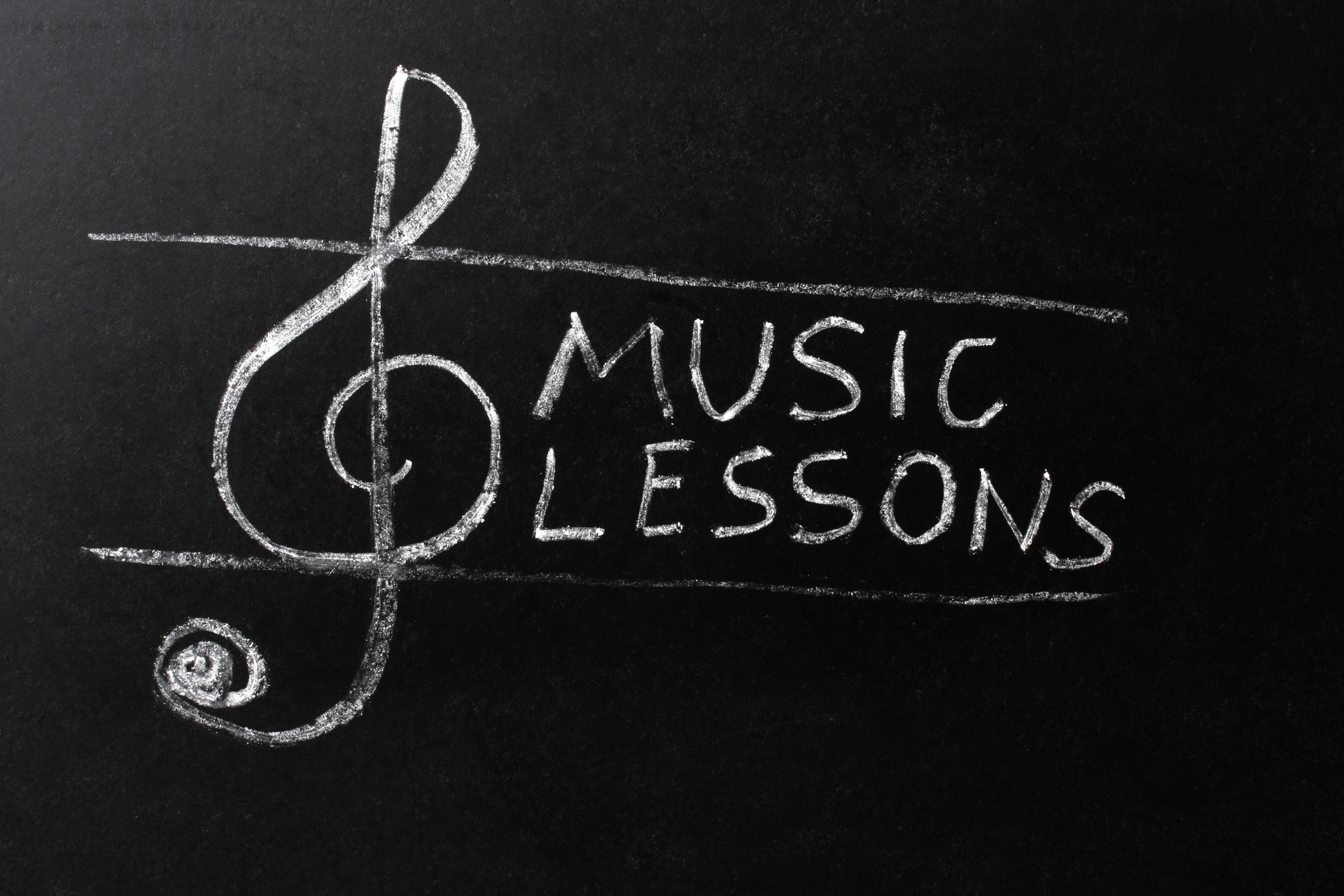 Music Lessons Chalk Text on Blackboard